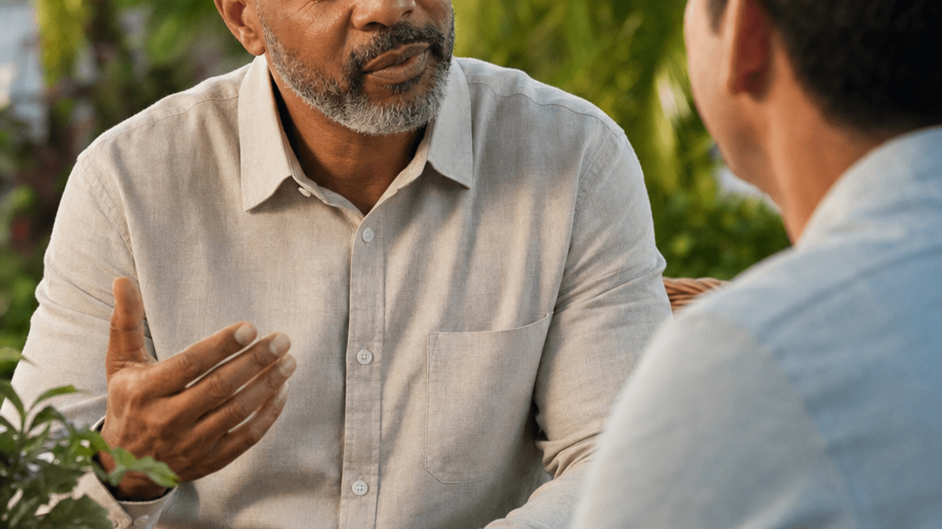 Hospice chaplain talking with a family member in a garden